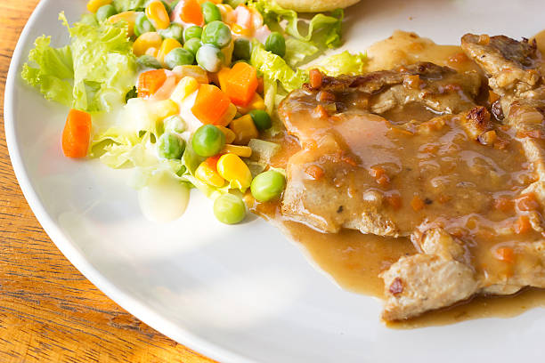 istock Pork chop steak with salad. 467070132