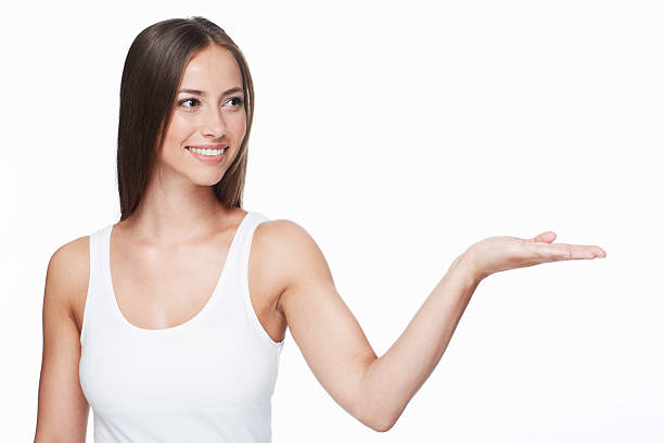 istock Young woman with arm out against white background 467070647