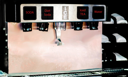 A soda dispensing machine typical of those found in fast food restaurants.