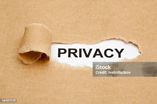 Torn Piece Of Paper Revealing The Word Privacy Stock Photo - Download Image Now - Authority, Brown, Concepts