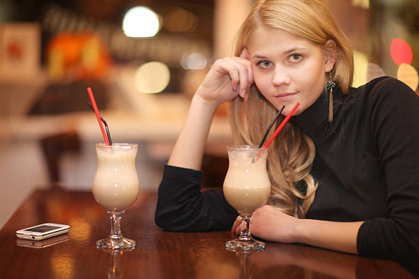 istock cheerful girl drinking coffee in a cafe at night 467077664