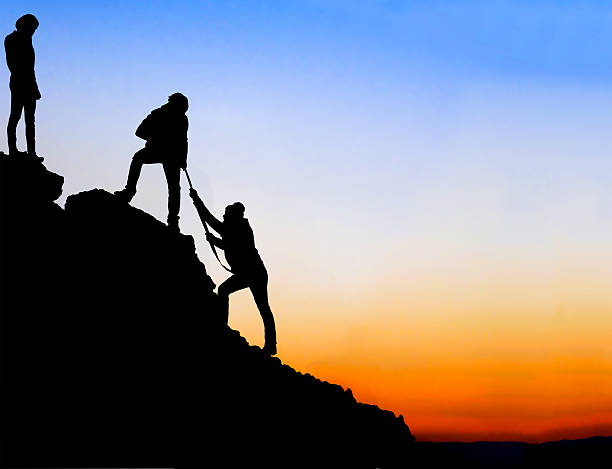 istock Silhouette of helping hand between two climber 467080934