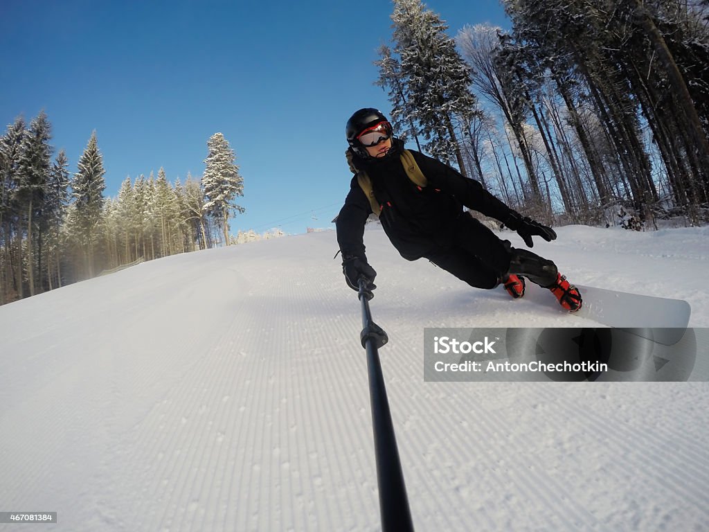 snowboarder on the slope man snowboarder on the slope on ski resort Bukovel 2015 Stock Photo