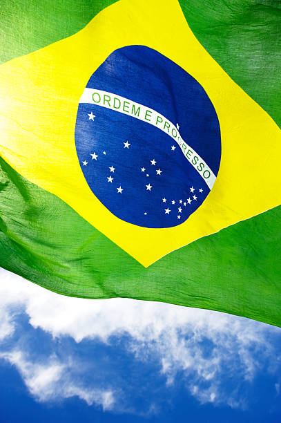 istock Brazilian Flag Flies in Bright Blue Sky 467081703