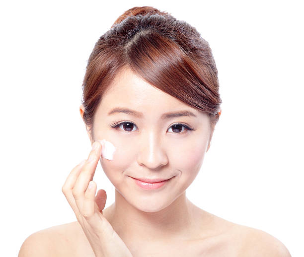 istock woman applying cosmetic cream on face 467083317