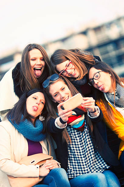 istock Friends taking a self portrait with a smart phone 467084712