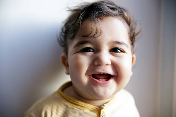 istock Charming 8 months old baby boy looking cheerful and laugh 467085052
