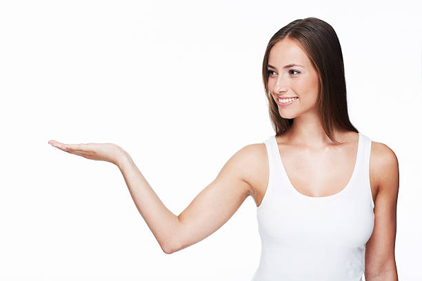 istock Young woman with arm out against white background 467088369