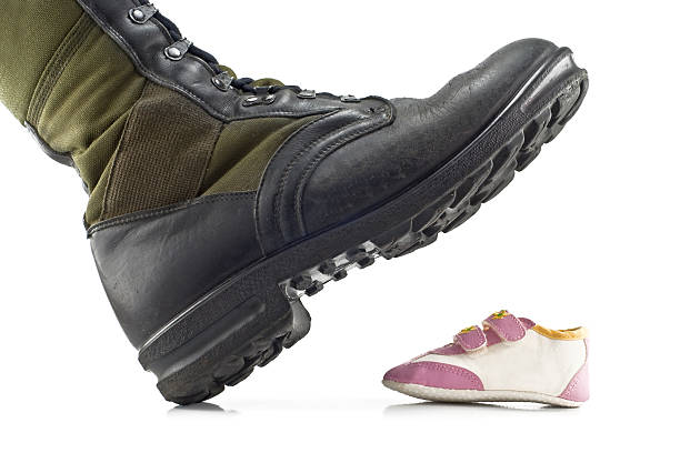 istock army boots crushing children's shoes 467089553