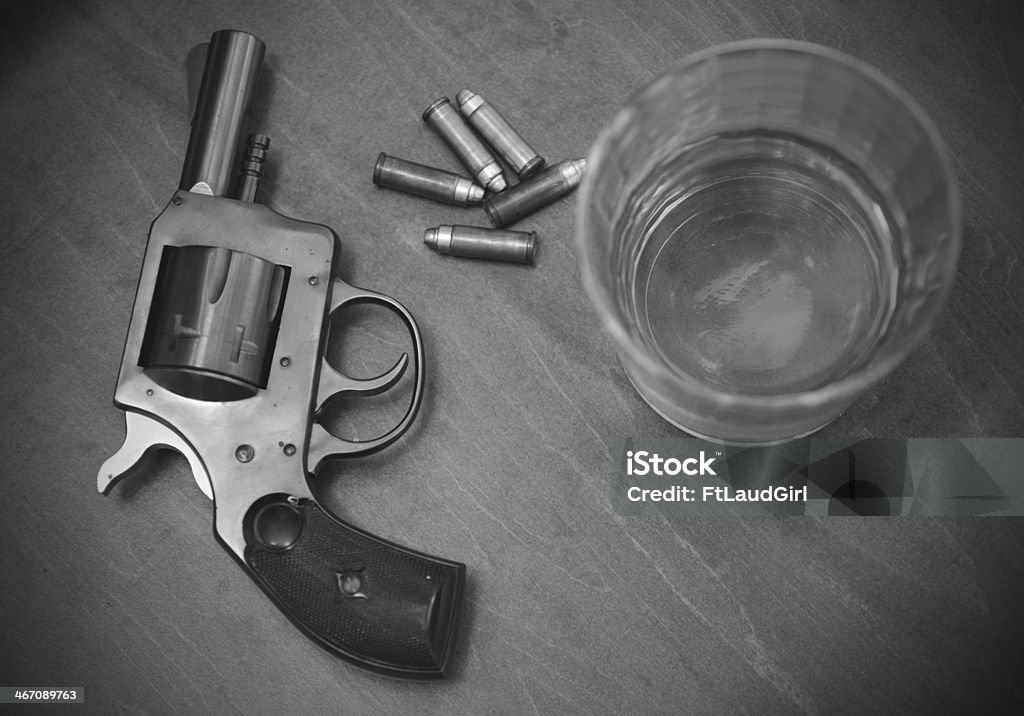 vintage pistol or gun with booze and bullets vintage pistol or gun with whiskey and bullets in black and white Gun Stock Photo