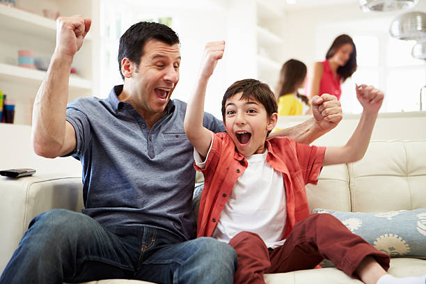 istock Father And Son Watching Sports On TV 467090481