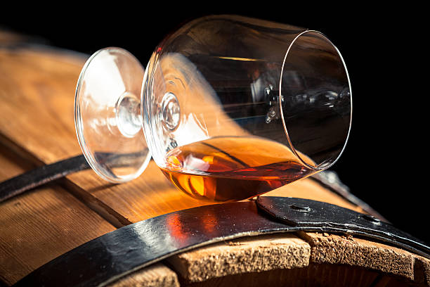 istock Glass of cognac on the old barrel 467097095