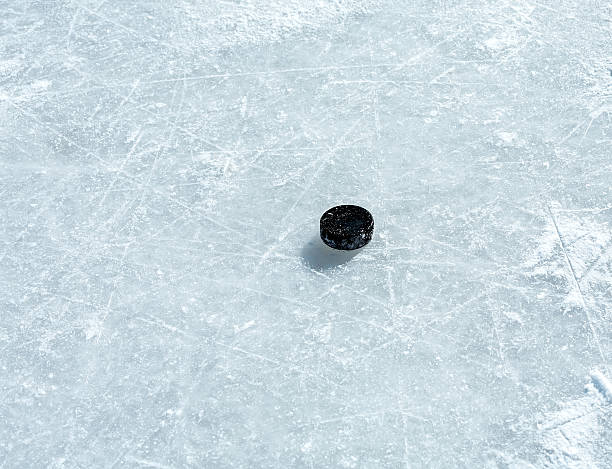 istock Hockey puck on ice rink 467100193