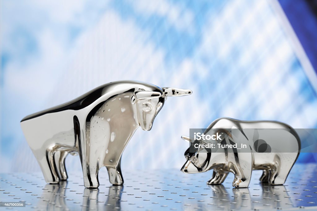 Bull and bear, high-rise building in the background Bull - Animal Stock Photo