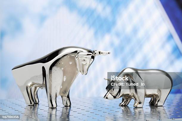 Bull And Bear Highrise Building In The Background Stock Photo - Download Image Now