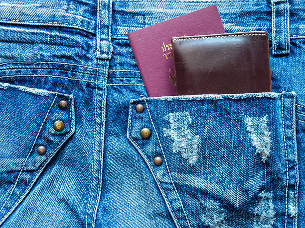 Passport book and wallet in back blue jeans pocket Passport book and wallet in back blue jeans pocket/ traveling concept jeans denim passport pocket stock pictures, royalty-free photos & images