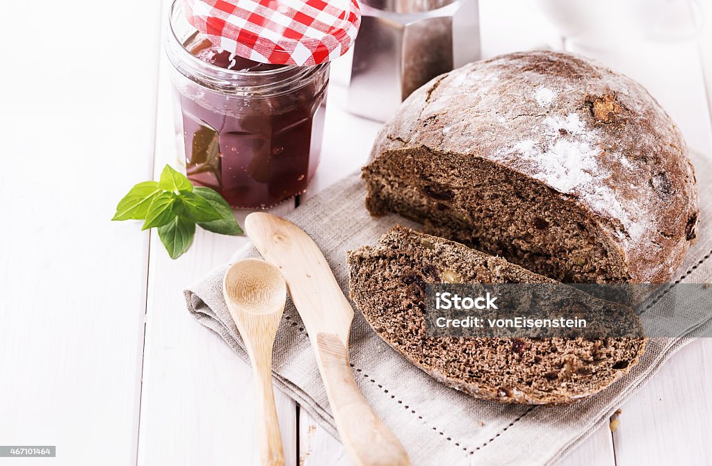 Freshly baked rye bread cob over white wooden background Rye sourdough bread with nuts and dry fruits on white wooden background. Selective focus, shallow depth of field, Copy space 2015 Stock Photo