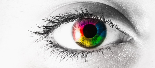 macro eye colored rainbow with white copy space. Letterbox.