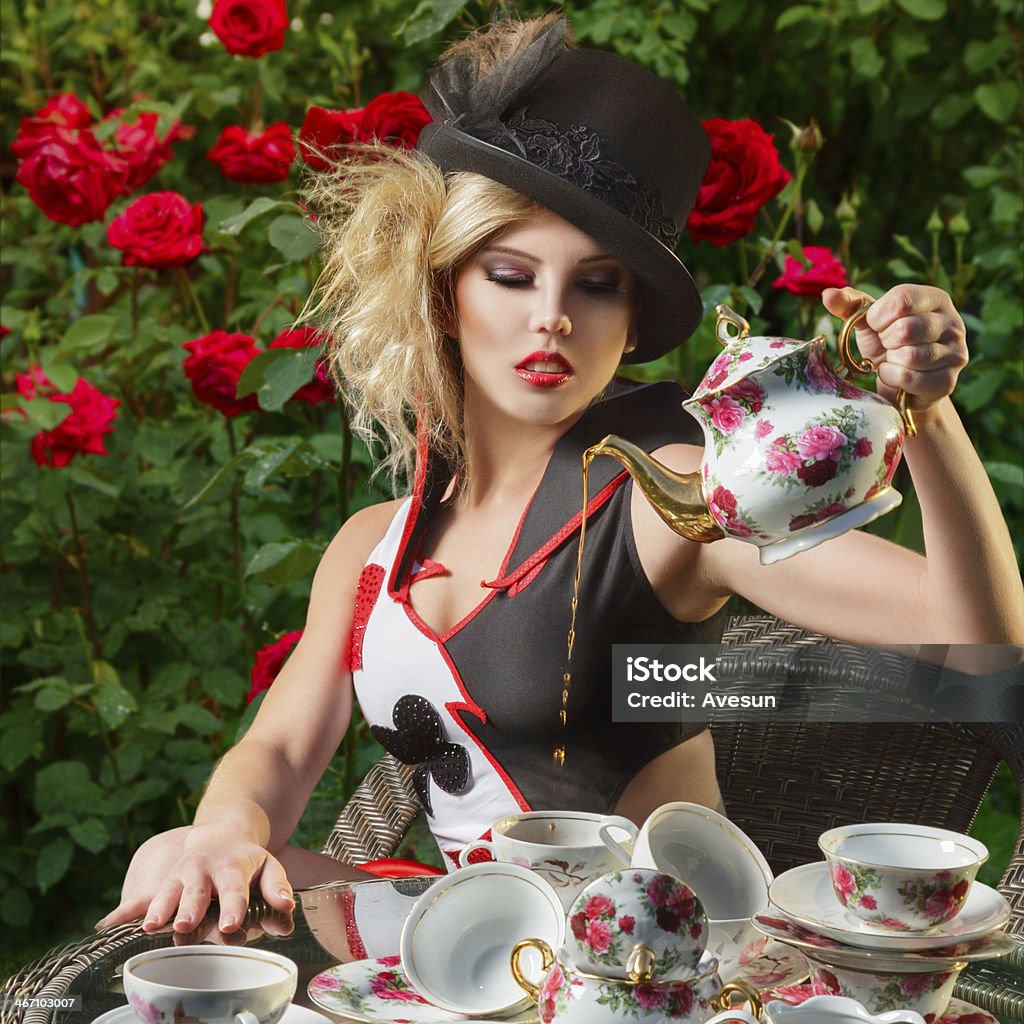 Young fashion woman Young woman posing as magnificent card queen from wonderland at mystic tea-party Royalty Stock Photo