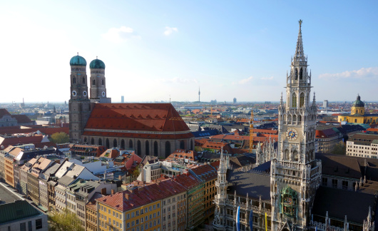 Wonderful panoramic view over Munich at dusk with its Frauenkirche, the New Town Hall and the Theatinerkirche - you also can see the silhoutte of the roof of the Olympic Stadium and its Tower on the horizon