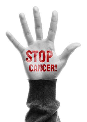 Hand with Stop Cancer text is isolated on white background.