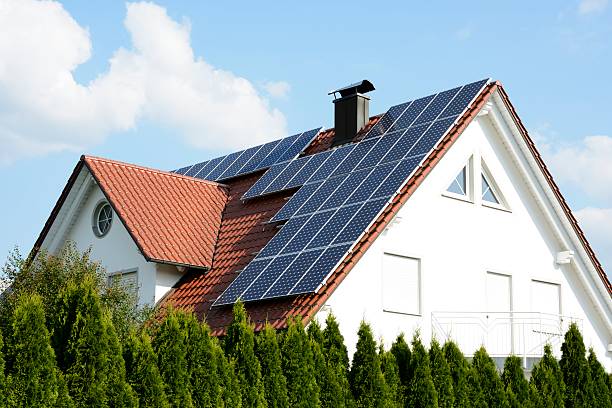 A house with solar panels on the roof stock photo