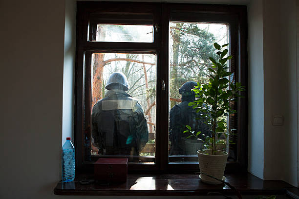 Riot police seen through the window Riot police seen through the window riot police stock pictures, royalty-free photos & images