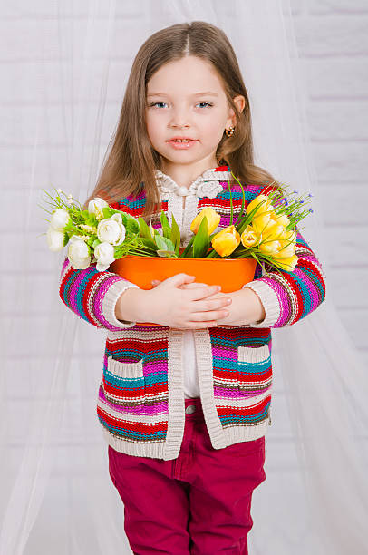 istock Little girl with spring flowers 467104804