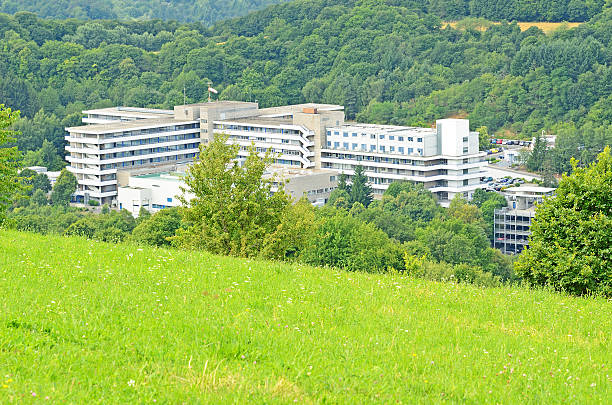 Public hospital building in forest valley stock photo