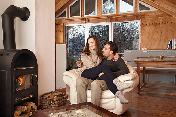 istock Woman sitting on man's lap while sitting next to a wood fire 467107272