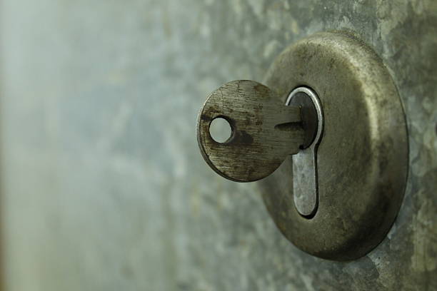 istock Closeup of an old keyhole with key 467107722