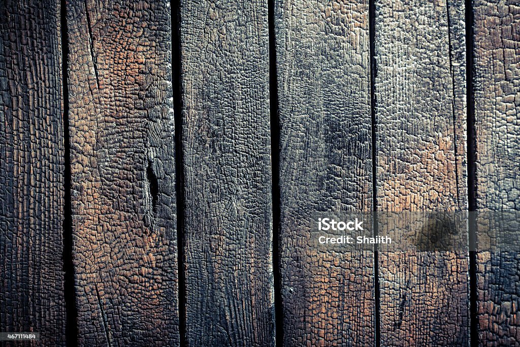 Black burnt wooden fence Black burnt wooden fence. 2015 Stock Photo