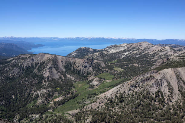 Lake Tahoe Nevada with snow laden pines, the blue waters of Lake Tahoe and the pristine Sierra Nevada mountains in the background.