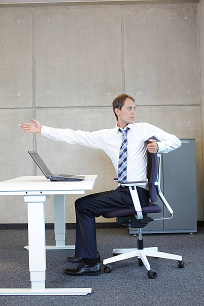 istock yoga in office. business man exercising at workplace 467113412