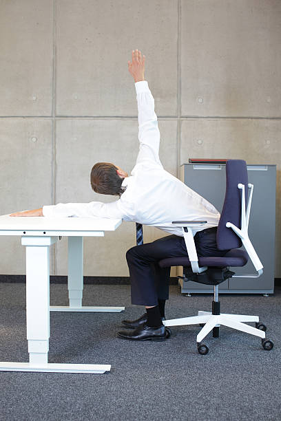 istock yoga in office. business man exercising at workplace 467113422