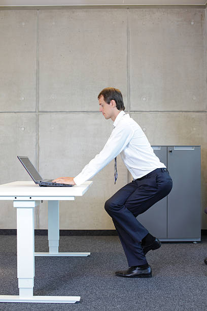 istock exercises in office. business man practicing yoga 467113424