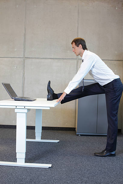 istock exercises in office. business man stretching leg 467113426
