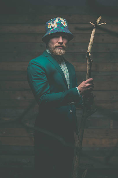 istock Serious Man in Formal Wear Holding Tree Branch 467114552