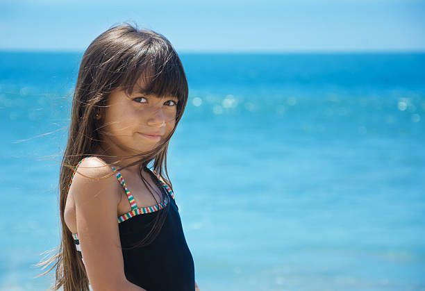 istock Girl by the ocean 467115317