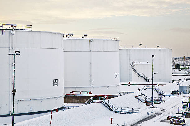 istock white tanks in tank farm with snow 467115345