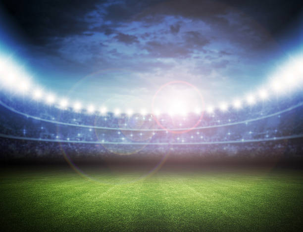 istock Brightly lit stadium with green grass 467116974