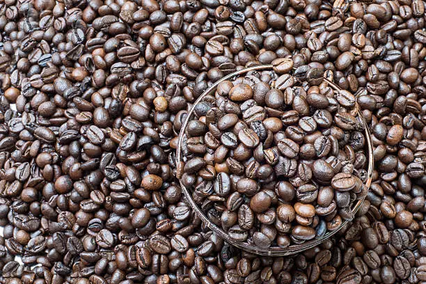 Coffeebean in cup, on coffeebeans background beans in cup