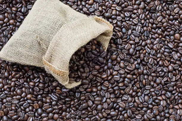 Burlap of coffee beans, on the coffee beans background