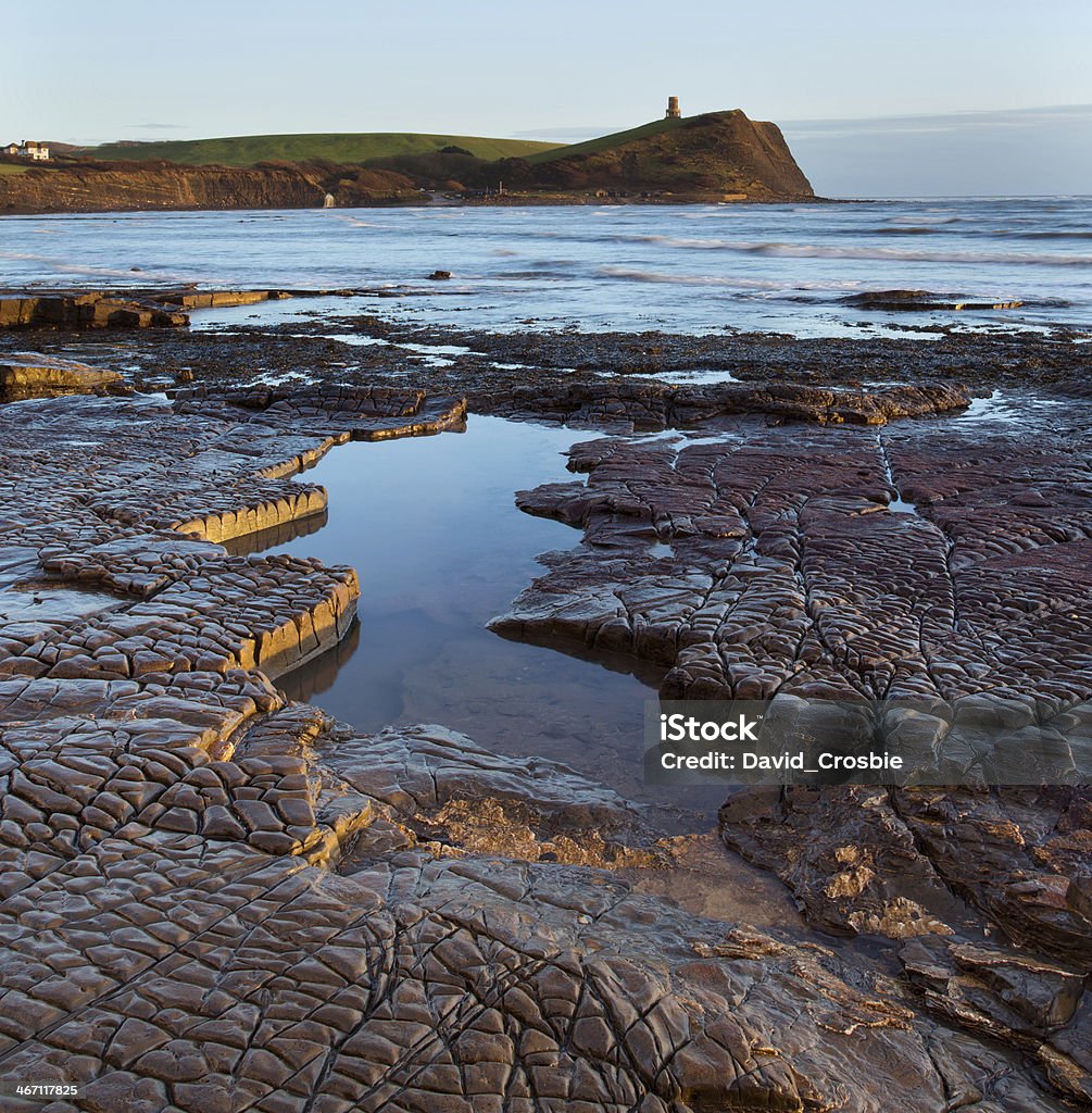 Kimmeridge, Dorset, UK - low tide, rock ledges & tidal pool The last of the late afternoon sunshine highlights the rock ledges and tidal pools at low tide at Kimmeridge, Dorset, UK. Part of Dorset's Jurassic coastline - a UNESCO world heritage site British Culture Stock Photo