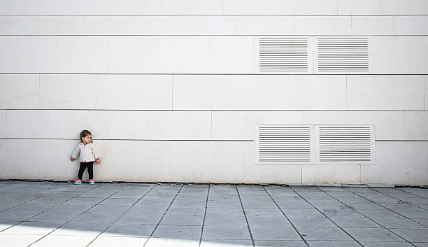 istock Little girl with sportive look posing over wall 467121448