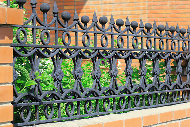 istock Metal forged fence on wall background 467122230