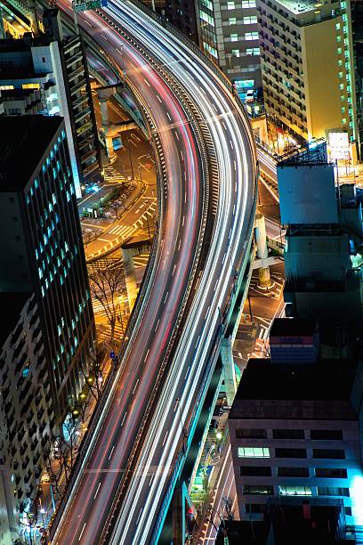 istock Greater Tokyo area dense building cityscape with car light trace 467125594