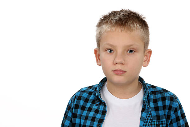 istock Handsome pensive young boy looking straight at the camera 467126955