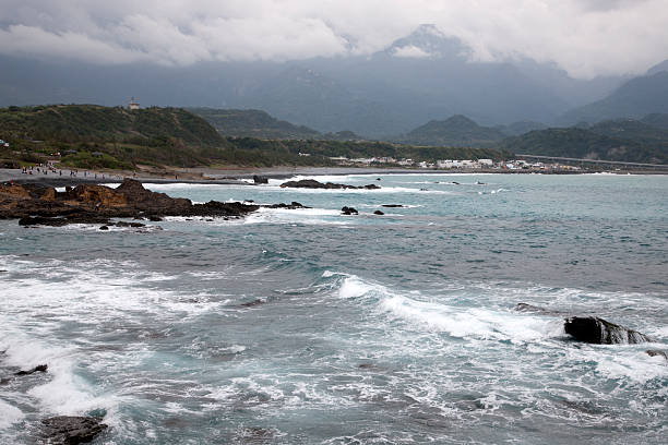 Taitung, Taiwan- November 16, 2014: Tourists visit a beach on the Eastern Taiwanese coastline, waves against the shore, Taiwan