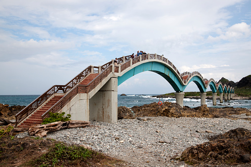 Taitung, Taiwan - November 16, 2014: Visitors walk across the Sansiantai Dragon Bridge to Sanxiantai Island, Taitung, Taiwan
